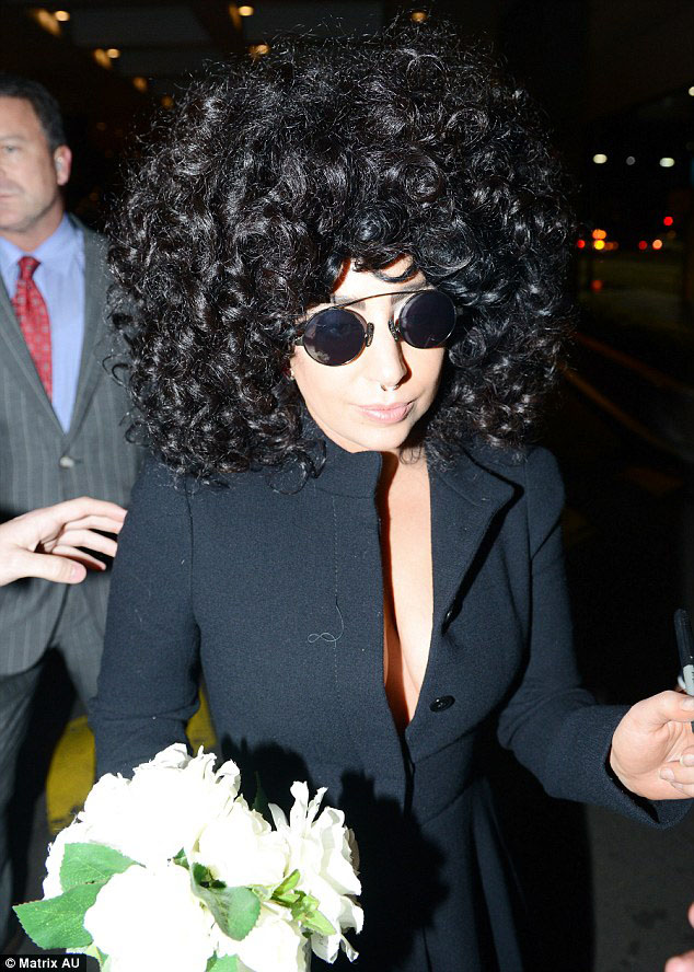 Lady Gaga departsHomeward: Gaga headed back to her Sydney hotel room carrying flowers and still wearing her Queen inspired wig after the show 