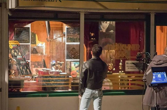 Rami Malik as Freddie - looking in shop window