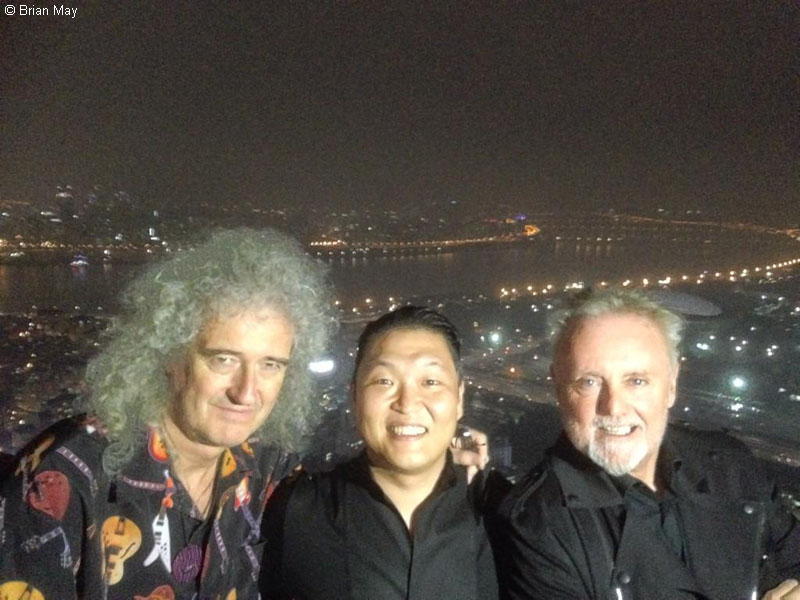 Brian, Psy, Roger with night time city backdrop