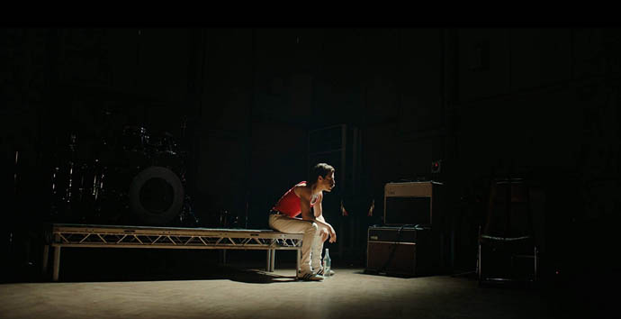 Rami Malek as Freddie seated alone