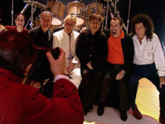 Maurice Bejart seated with Brian May, Roger Taylor et al, Paris