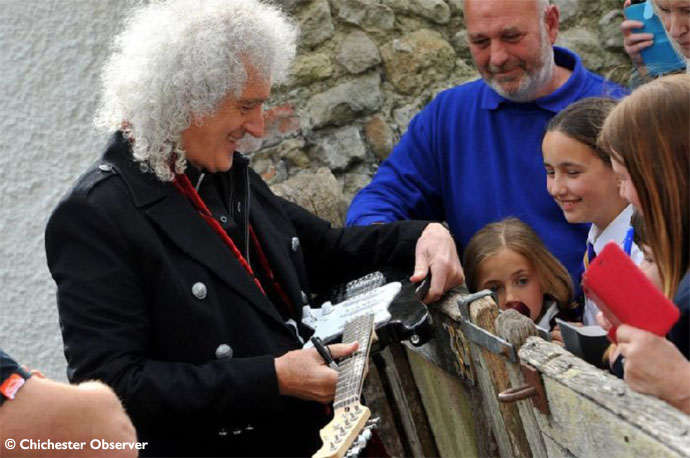 Brian signs Charlie Bone's guitar - Chichester Observer