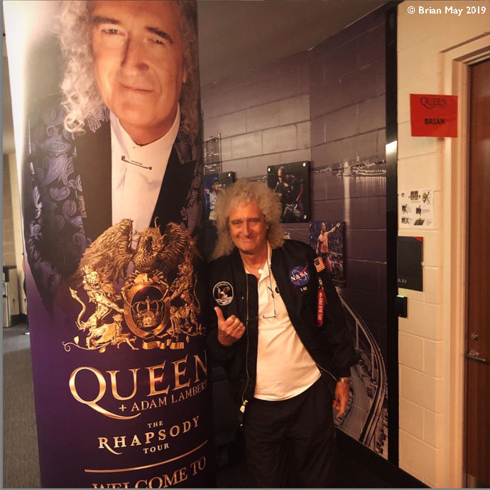 Bri poses by poster Little Caesars Arena lobby