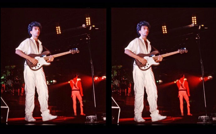 John Deacon and Freddie on stage - cross-eyed