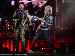 Chicago - United CenterAdam Lambert (left) sings alongside Queen guitarist Brian May at the band’s concert Friday at the United Center. Santiago Covarrubias / For the Sun-Times