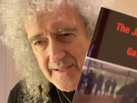 Brian May shows the Gatcomb Project pamphlet