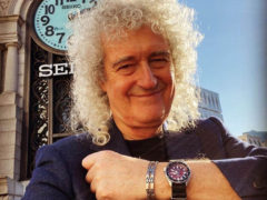 Bri shows watch close up by clock