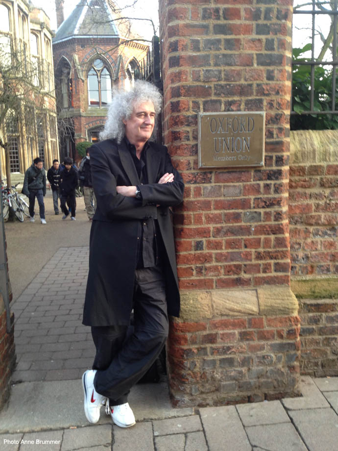 Brian May next to Oxford Union sign