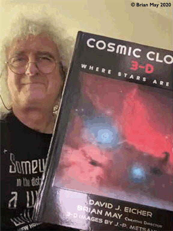 Brian May shoiwing Cosmic Clouds 3-D book