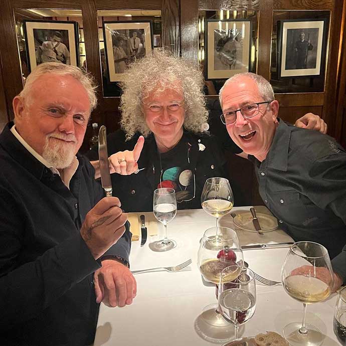 Roger, Brian and Ben Elton celebrating